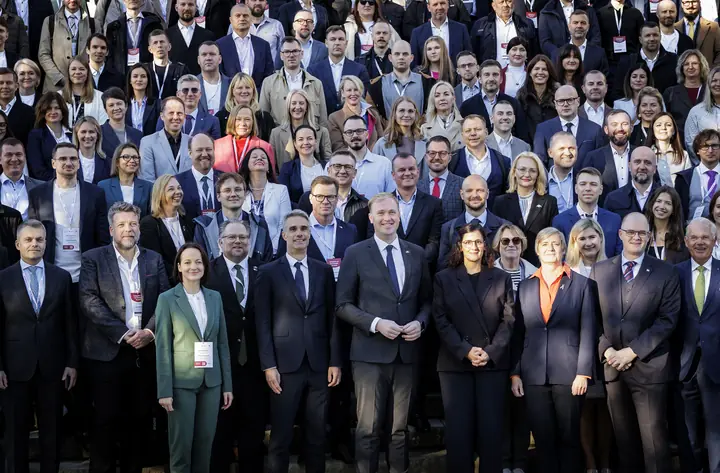 The front rows of the Latvian delegation, with the mission leadership in the centre, closer up.