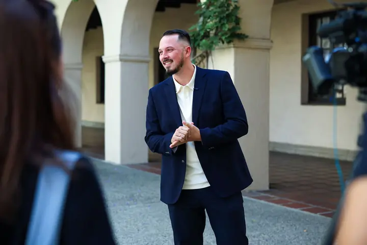 Aleksandrs Gusevs of Double Helix Technologies smiling during the on-camera interview at Caltech.