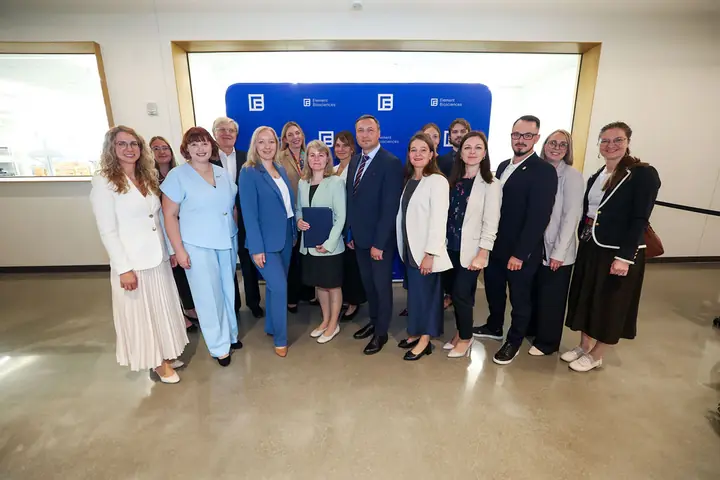The biomedicine group with the signed memorandum in front of the Element Biosciences backdrop.