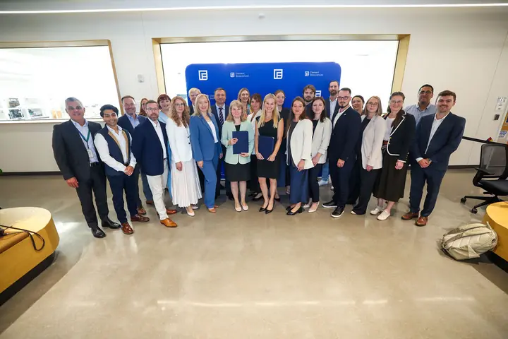 The delegation and its hosts in front of the Element Biosciences backdrop.